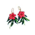 Handcrafted polymer clay Blooming Hibiscus Dangle Earrings with red flowers, green leaves, and trailing vines, adding botanical elegance to any look