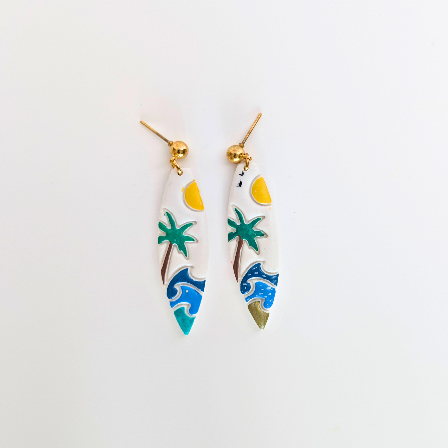 Handcrafted polymer clay tropical earrings featuring a palm tree, ocean waves, and golden sun, designed for a vibrant, vacation-inspired look