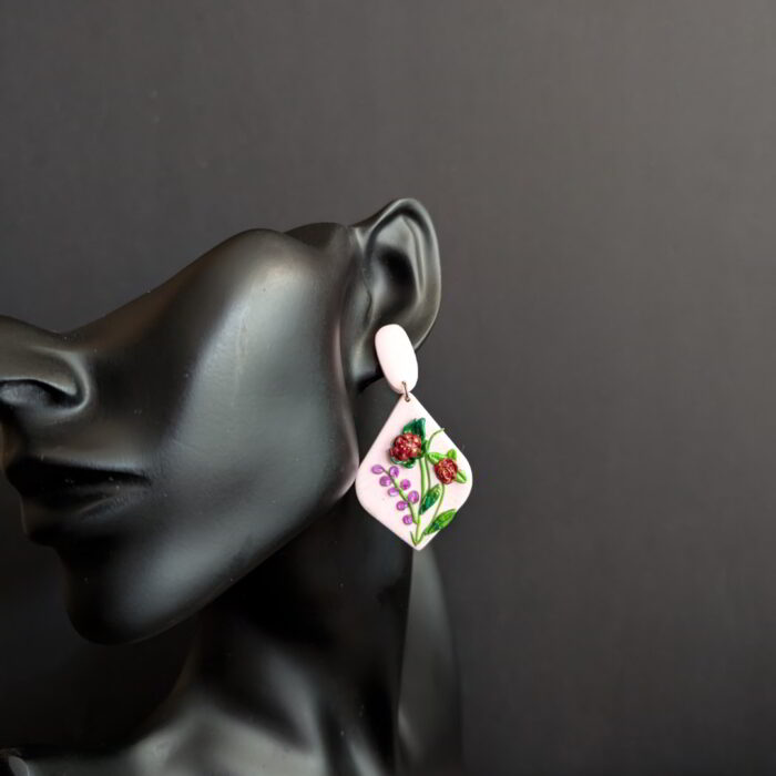 Handcrafted light pink floral earrings with red blooms, green leaves, and small pink flower accents.